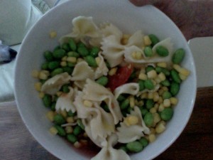 Dinner of tomato and partially thawed: edamame beans, corn, pasta